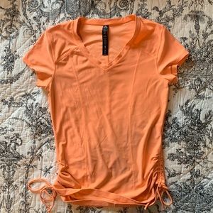 RBX orange active top with cute drawstrings on the sides.